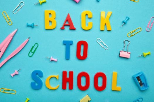 Back to School alphabet letters with school supplies on blue background
